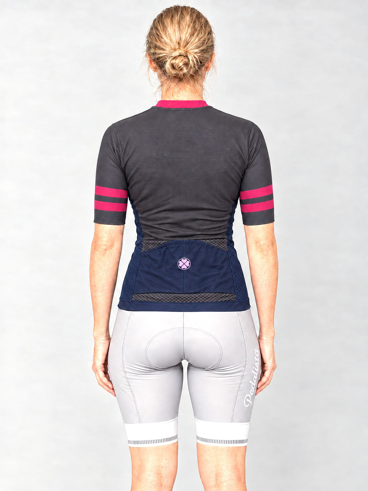 Model wearing the Blue Steel jersey with silver bib shorts, back view