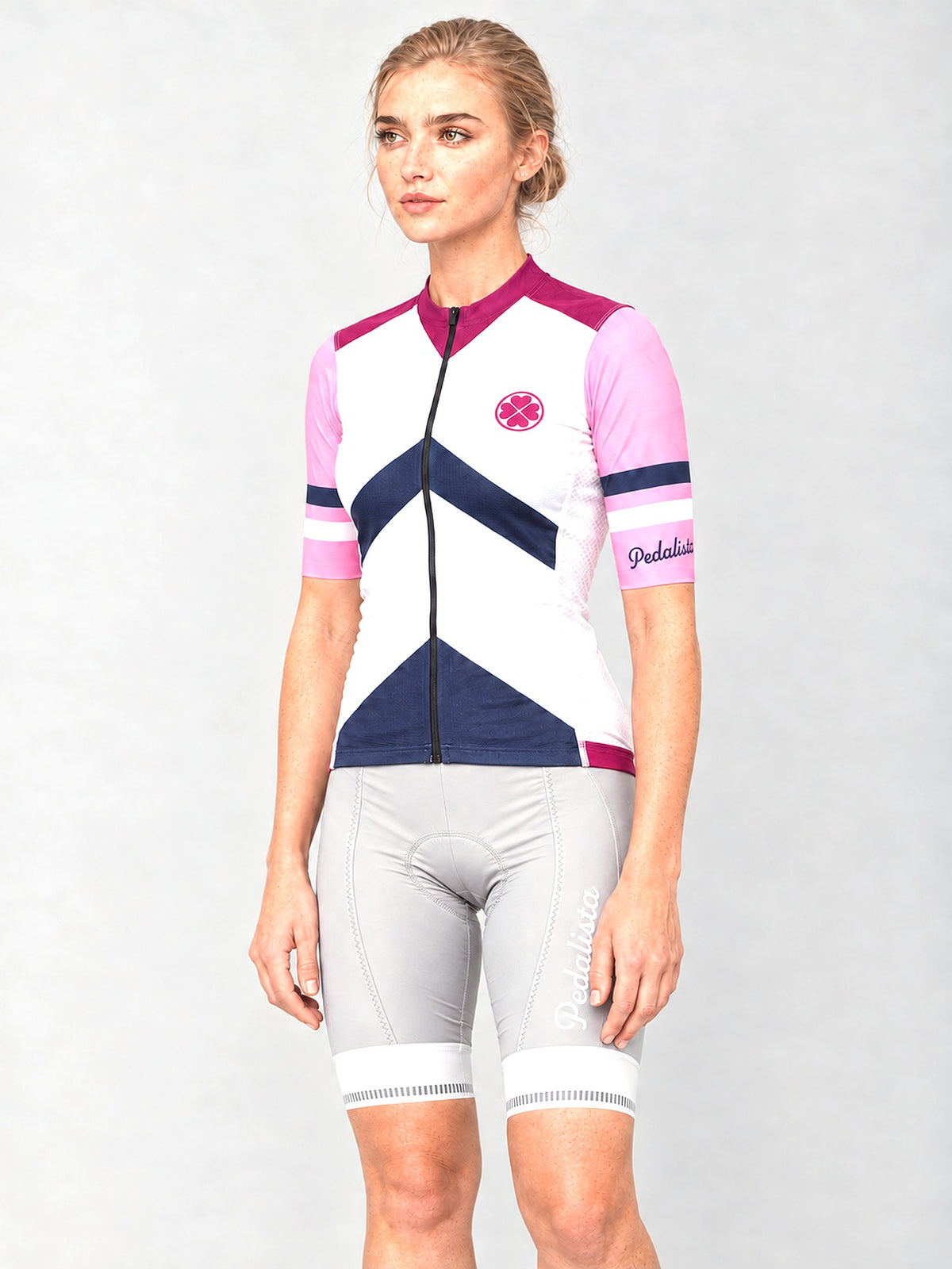 Model wearing the Pink Attack jersey with silver bib shorts, side view