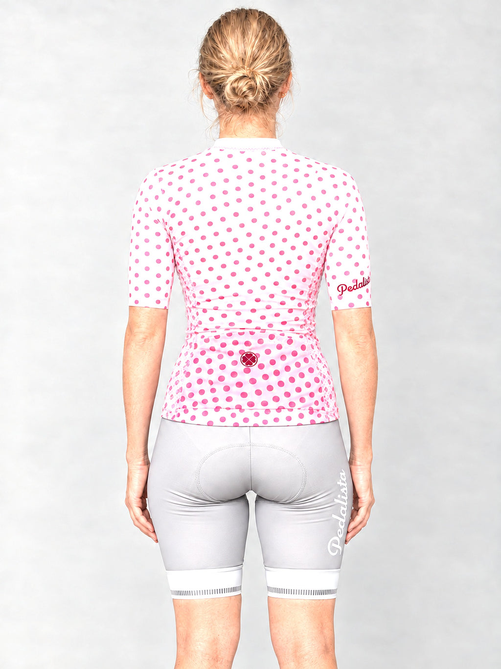 Model wearing the Queen of the Mountain jersey with silver bib shorts, back view