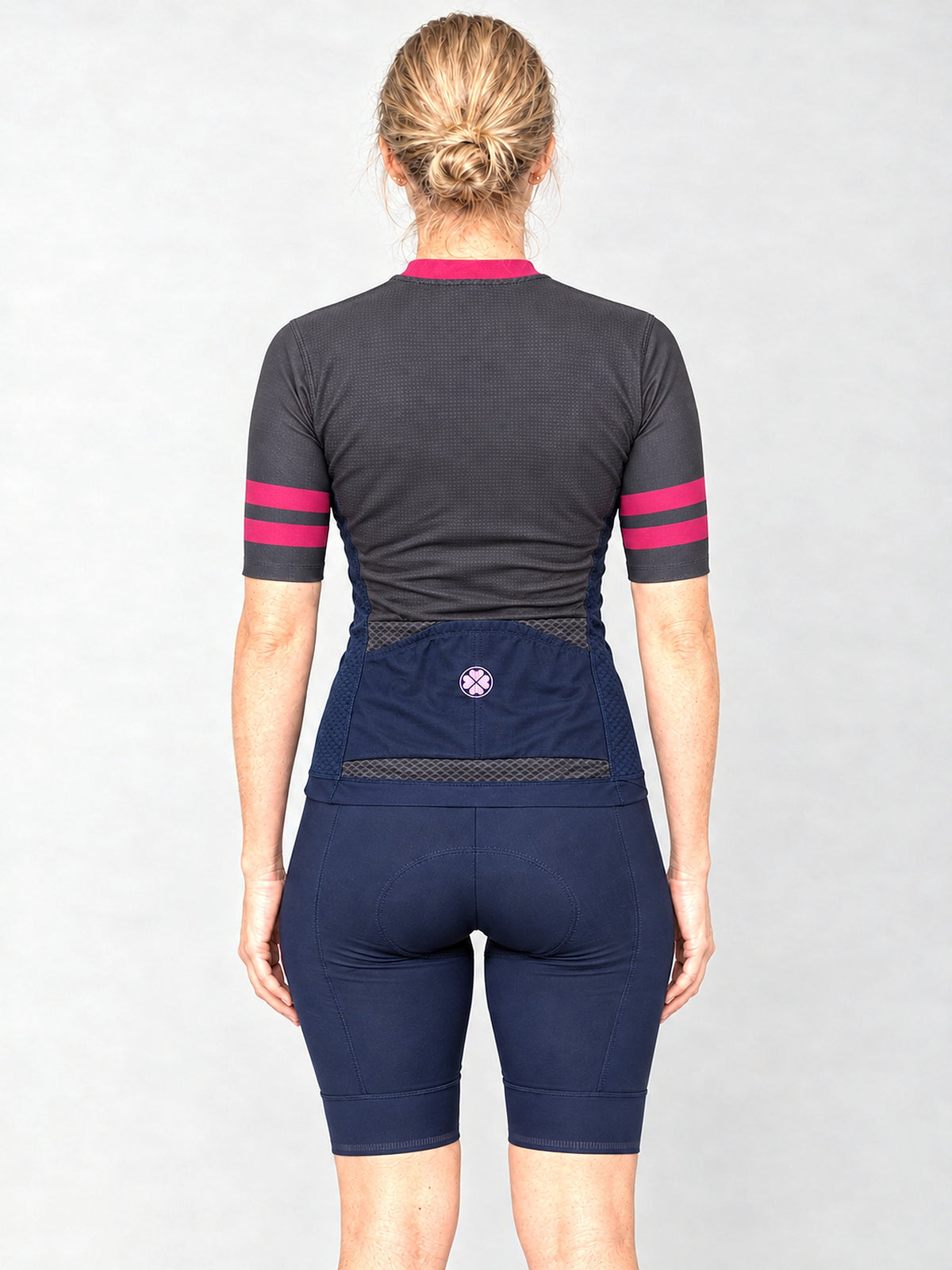 Model wearing the Blue Steel jersey with navy bib shorts, back view